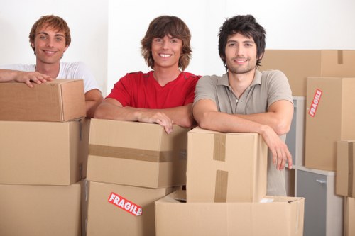 Local Battersea movers carrying furniture through a residential street