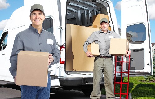 Professional movers loading boxes into a Battersea removal van