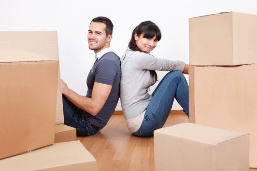 Furniture movers carrying items in Battersea street