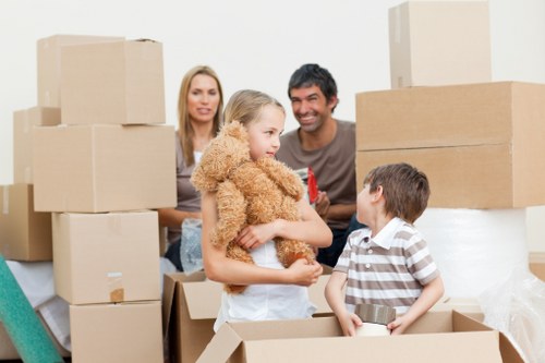 Careful packing of household items by movers in Battersea